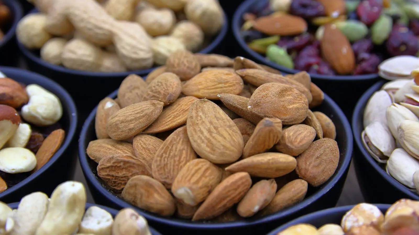 Bowls of almonds, pistachios and mixed nuts