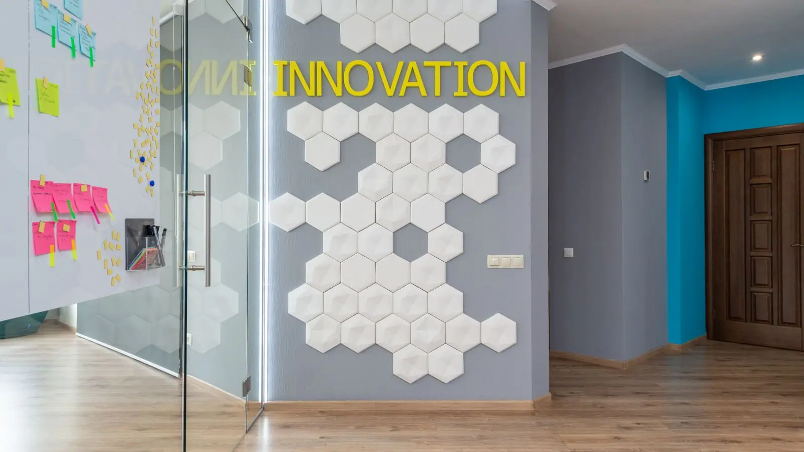 Office corridor next to a glass-walled meeting room